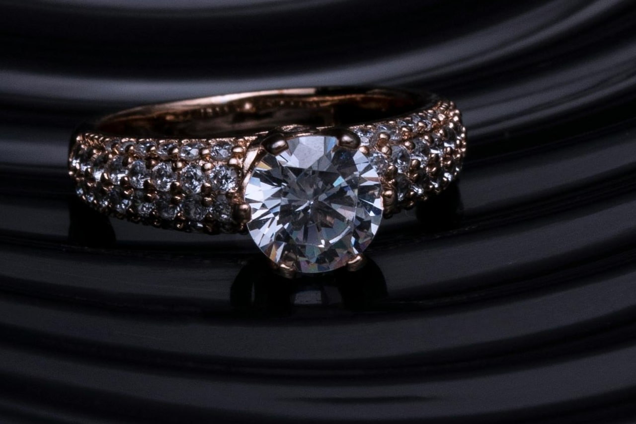 close up image of a round cut diamond engagement ring with side stones