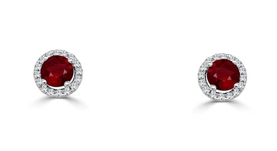 a pair of ruby stud earrings in a white gold diamond halo setting