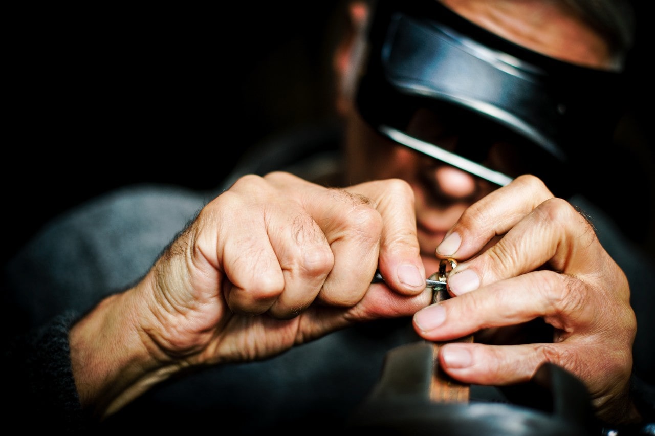 A close-up of an artisan creating a custom ring.