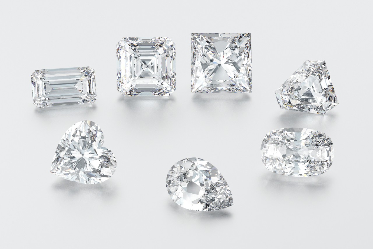 A close-up of a variety of diamond cuts on a white background.